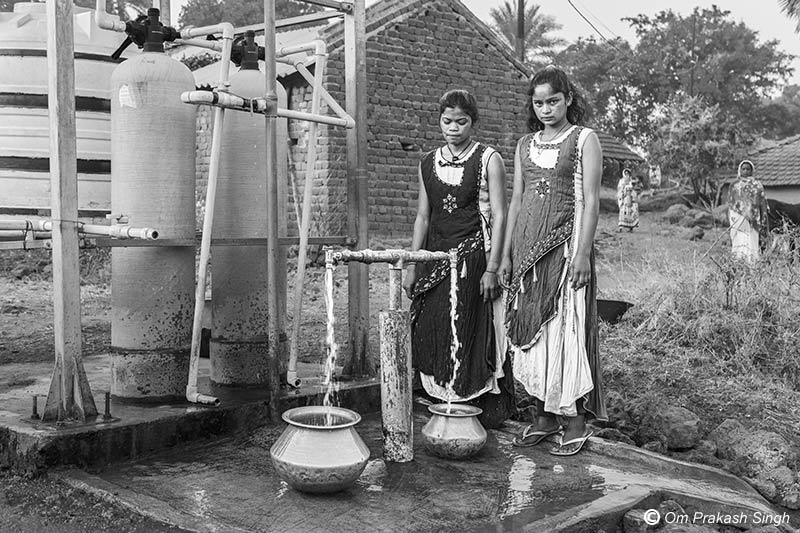 Optimizing traditional drinking water sources for accelerating change - Collecting treated drinking water from the public standpoint near the filters in Jiyatpani Tola, village Dumarpahar, district Dumka, Jharkhand